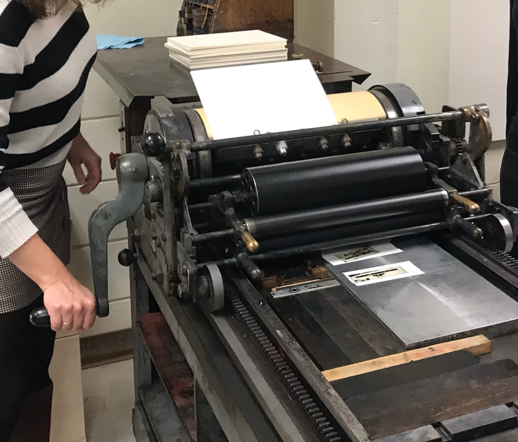 Natalie Loveless operating the Vandercook printing press